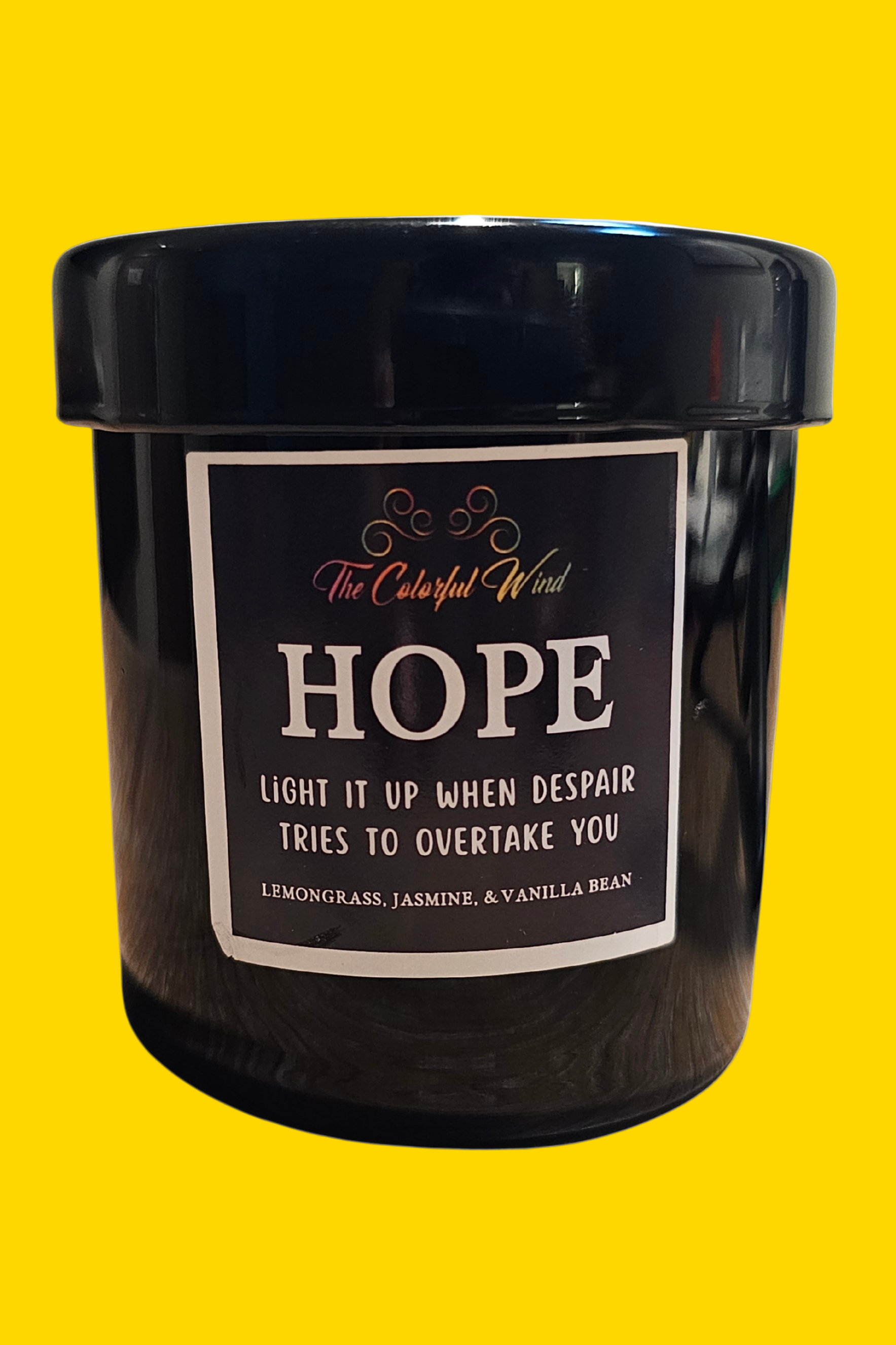 Black candle with a label on a white background